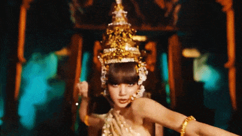 a woman in a costume with a crown on her head is dancing .