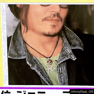 a picture of a man with a beard and a necklace that says tc
