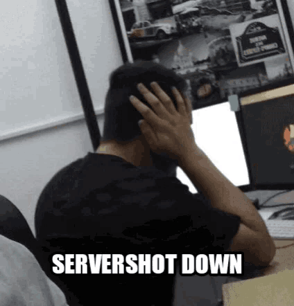 a man is sitting in front of a computer with his hands on his head and the words servershot down written on the bottom