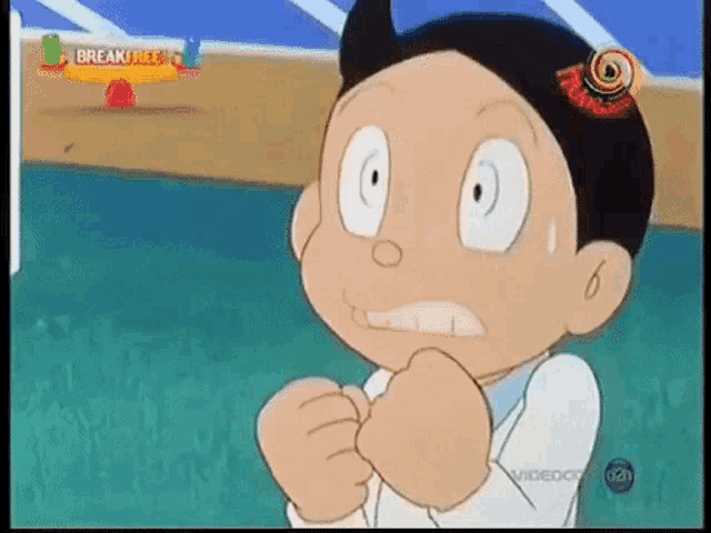 a cartoon character is making a funny face while standing on a field .
