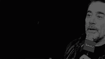 a black and white photo of a man laughing .