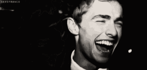 a close up of a man 's face with a smile on his face .
