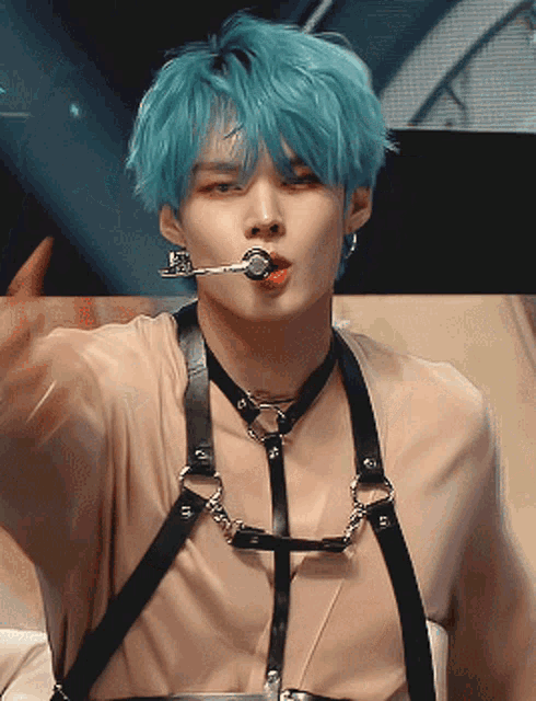 a man with blue hair and a harness around his neck