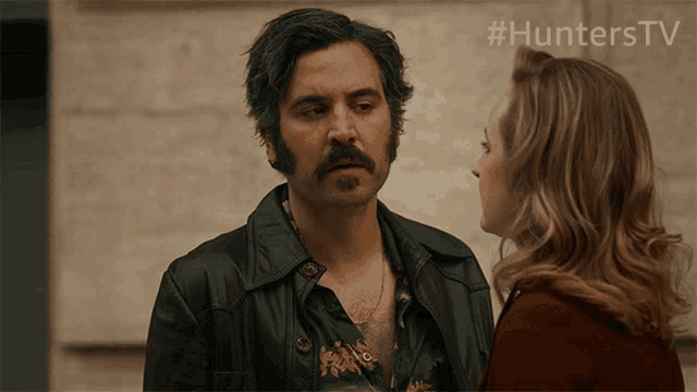 a man and a woman are looking at each other with the hashtag #hunterstv behind them