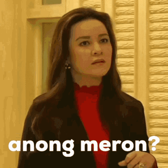 a woman is wearing a red sweater and a black jacket and says anong meron ?