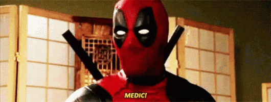 a man in a deadpool costume is standing in front of a folding screen and says medici .