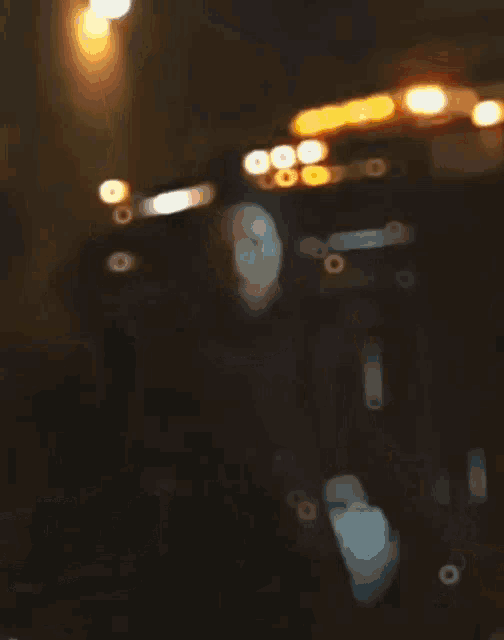 a woman is standing in front of a tow truck with a light on top of it .