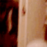a blurry picture of a bathroom with a toilet and a shower stall .