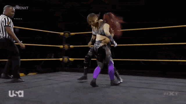 two women are wrestling in a ring with a referee and usa written on the bottom