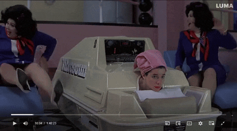 a video of a woman sitting in a machine that says luma on the bottom