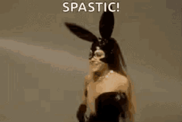 ariana grande is wearing a black bunny mask and black gloves .