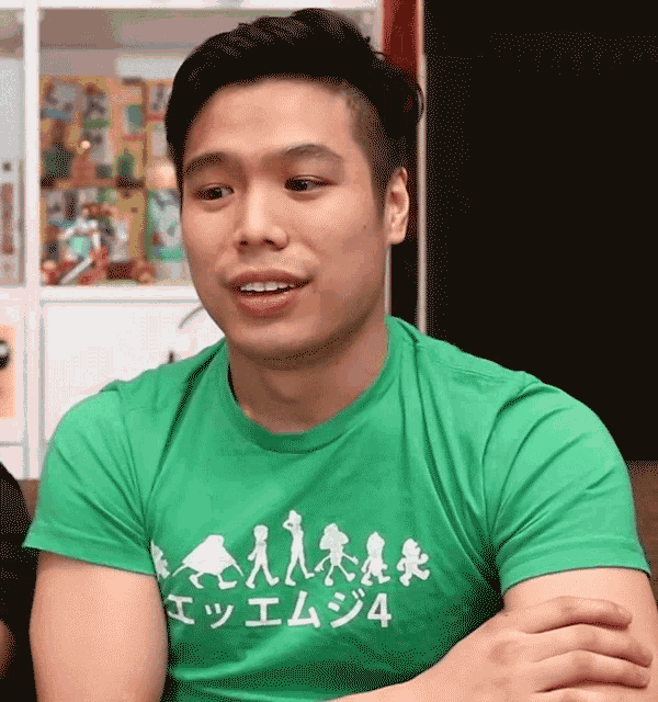 a man wearing a green t-shirt that says 4
