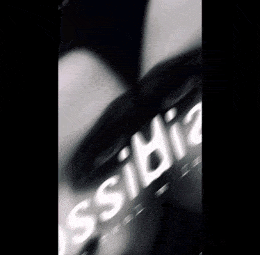 a blurry picture of a person 's face with the word " ossibi " written on it