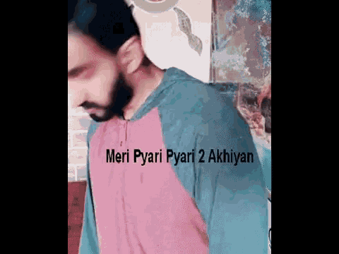 a man with a beard is wearing a pink and blue shirt with the words meri pyari pyari 2 akhiyan on it