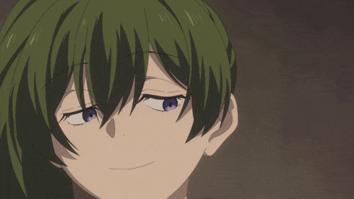 a close up of a person with green hair and blue eyes