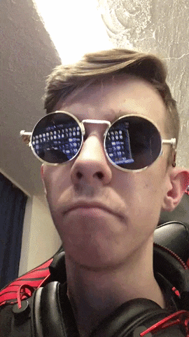 a man wearing a pair of round sunglasses with a reflection of a keyboard