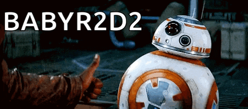 a person giving a thumbs up next to a robot that says babyr2d2 on it