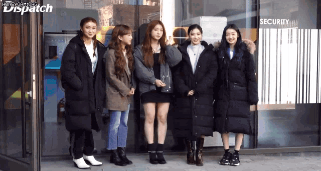 a group of girls standing in front of a building that says dispatch
