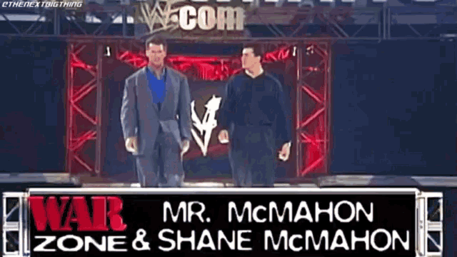 two men standing next to each other in front of a sign that says war zone