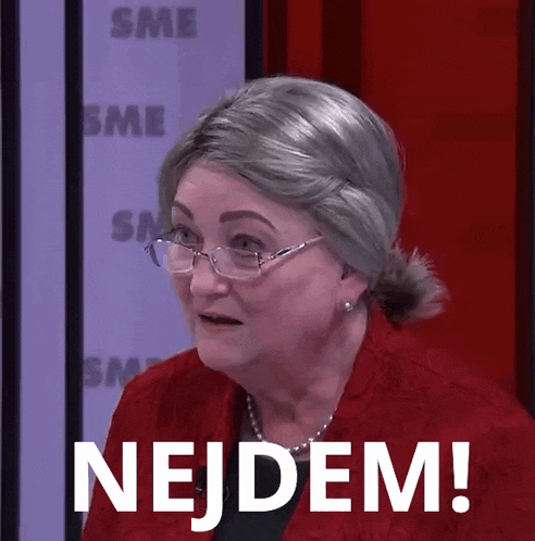 a woman wearing glasses and a red jacket has the word nejdem in white letters