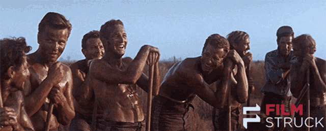 a group of men are standing in a field and the words film struck are on the bottom