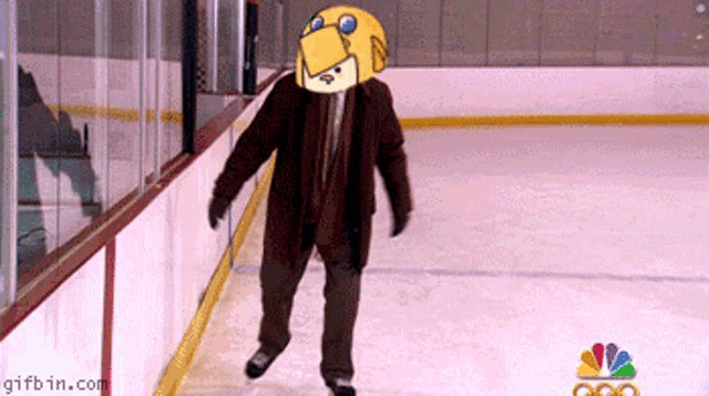 a man is walking on a ice rink with a gifbin.com logo in the background