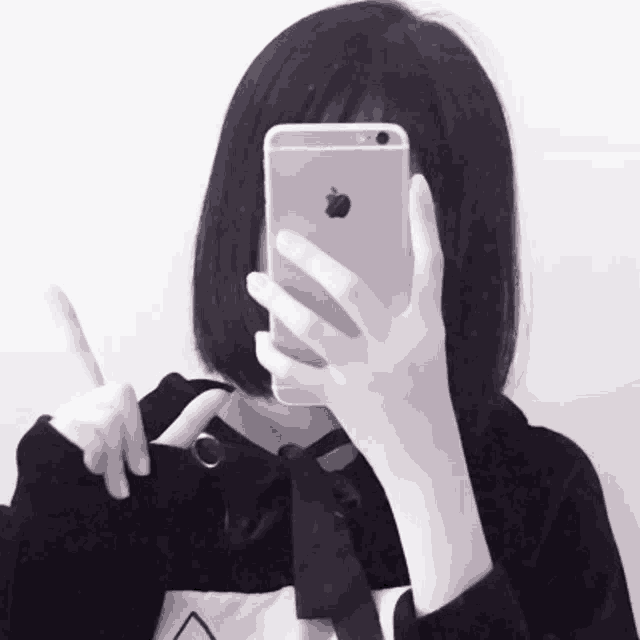 a girl is taking a picture of herself with an apple phone
