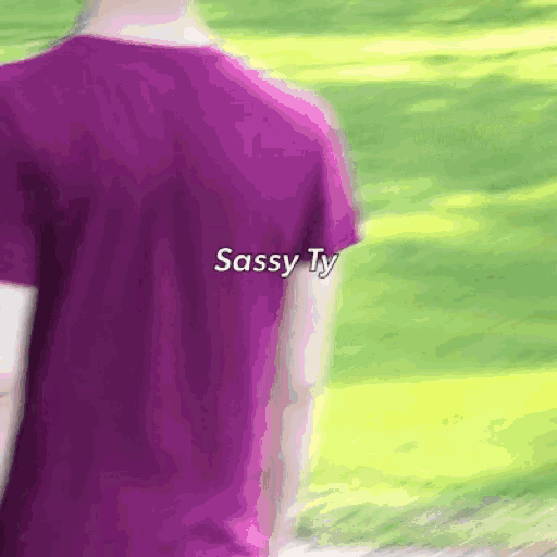 a person wearing a purple shirt that says sassy ty on the back