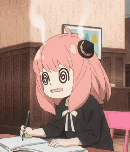 a girl with pink hair is sitting at a table writing in a book