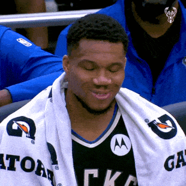a man wearing a black and white jersey with gatorade on it