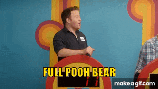 a man is standing in front of a podium that says full pooh bear