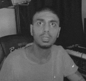 a close up of a man 's face with a surprised look on his face .