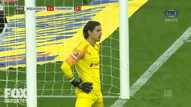 a soccer goalie stands in front of a net during a fox sports broadcast