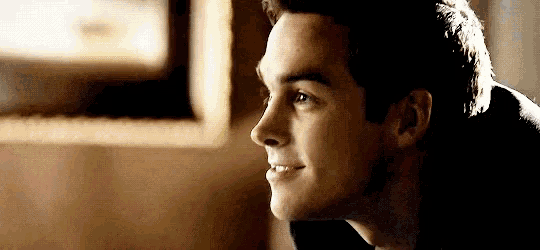 a close up of a man 's face with a smile on it .