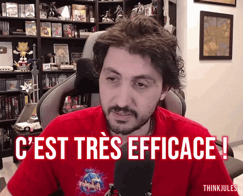 a man in a red shirt says " c'est tres efficace " in front of a microphone