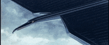 a close up of a plane 's wing in the sky