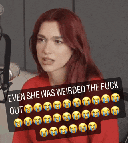 a woman with red hair is sitting in front of a microphone with a caption that says " even she was weirded the fuck out