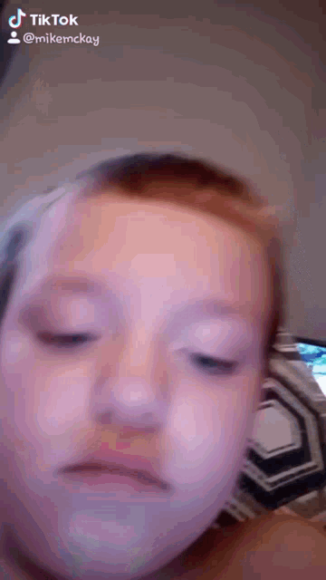 a close up of a child 's face with a tik tok watermark