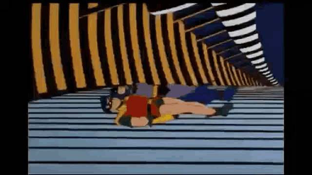 a cartoon of batman and robin laying on a roof .