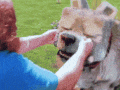 a woman is petting a statue of a lion .
