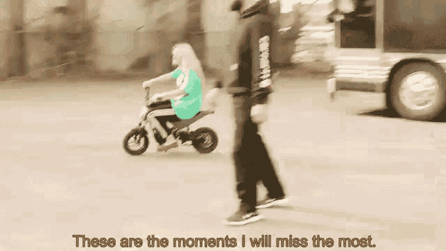 a man is walking next to a woman riding a small motorcycle on a street .