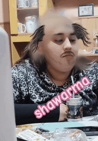 a woman sitting at a table with a straw in her mouth and the word shawarma written on the bottom