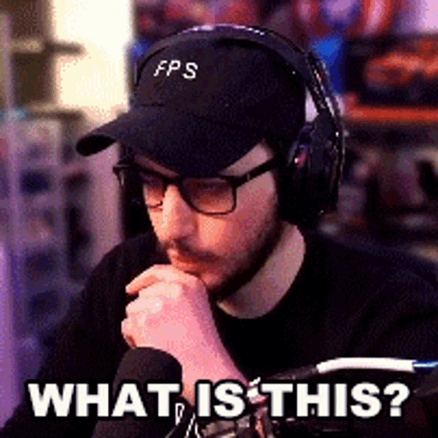 a man wearing a hat and headphones says what is this .