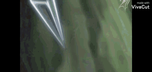 a person is holding a sword in their hand and a sword is flying through the air .