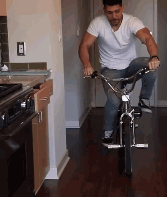 a man is riding a bike in a kitchen