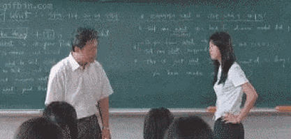 a man and a woman standing in front of a blackboard