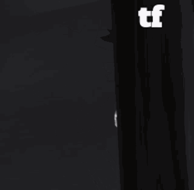 a girl with horns is peeking out from behind a wall with the letters tf above her