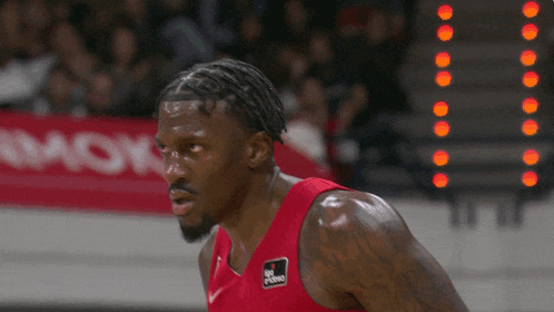 a basketball player wearing a red jersey that says king