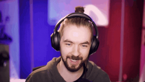 a man with a beard wearing headphones and a bun on his head