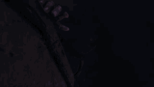 a person with a tattoo on their arm is holding onto a pole